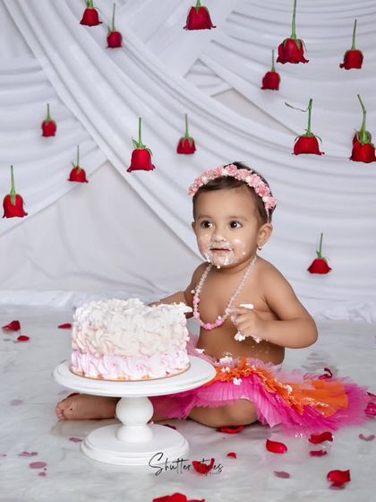 A sweet look at the camera amidst the cake-smashing fun.