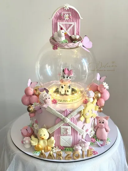 The farmland cake with the globe light turned on. Adding simple lighting elements can make your fondant creations even more magical.