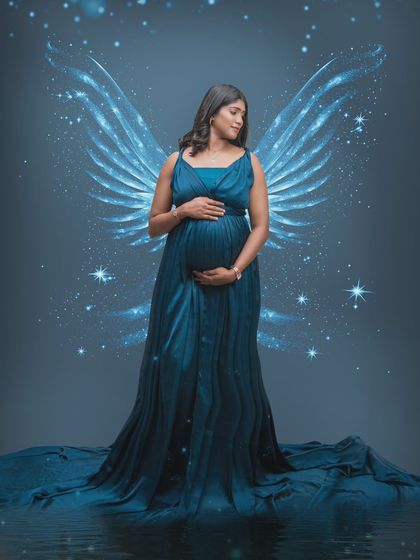 An angelic glow of motherhood. This portrait takes beauty to a celestial level with wings that symbolize strength, grace, and love.