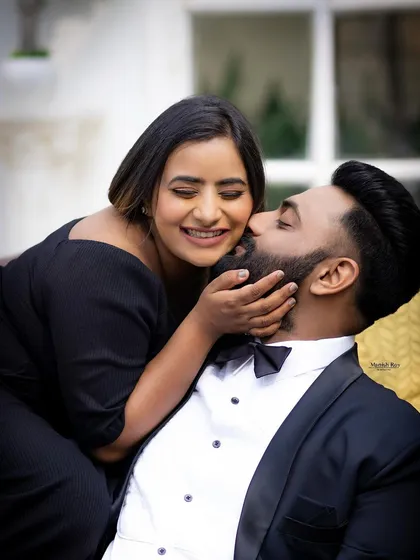 A sweet and playful moment. Her makeup is fresh and natural, with a beautiful smile being the main focus.