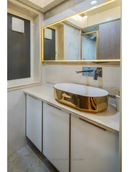 A close-up of the stunning gold sink, which serves as a luxurious focal point in the bathroom.