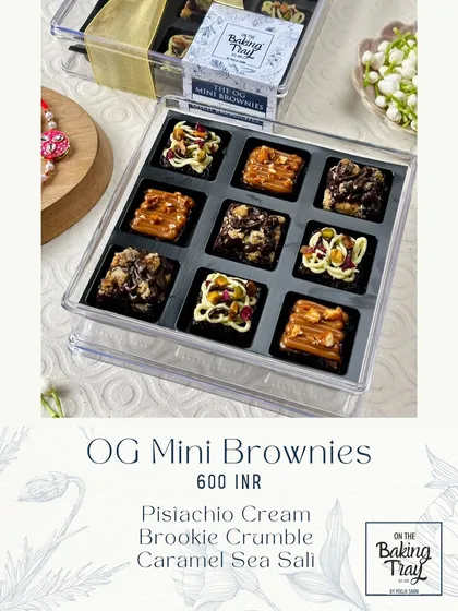 A box of my OG Mini Brownies, featuring an assortment of flavors like Pistachio Cream, Brookie Crumble, and Caramel Sea Salt. Each one is a fudgy, bite-sized delight.