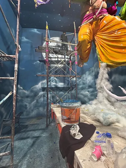 The reality of creating large-scale art. The pandal is our workshop, filled with paint, tools, and scaffolding. Every piece is created live on-site just before the festival begins.