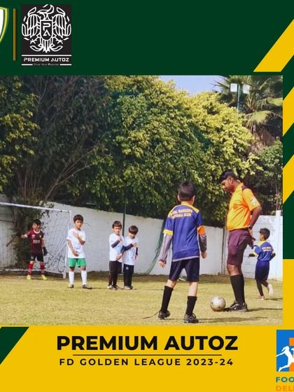 A referee sets up a free kick during a Golden League match, with players from both teams ready for action.