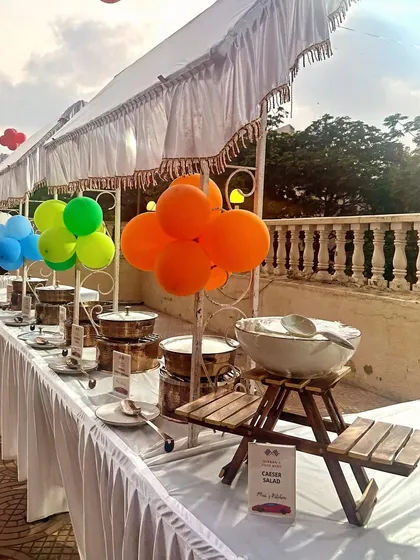 Another look at this cheerful outdoor buffet. The white canopies and table skirting create a clean look that works for any party theme, from birthdays to casual brunches.