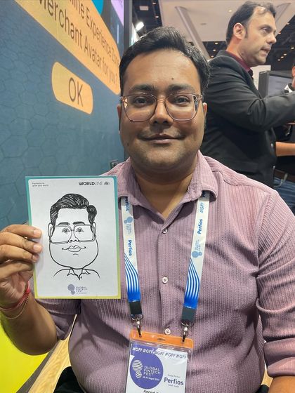 A smiling attendee at the Jio World Convention Centre, holding his branded caricature from a fintech festival.