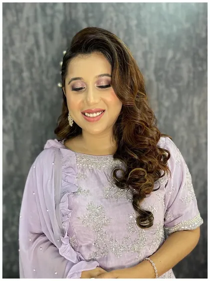 A beautiful, happy client ready for her event. The soft, shimmery makeup and elegant hairstyle come together for a look that is both charming and sophisticated.
