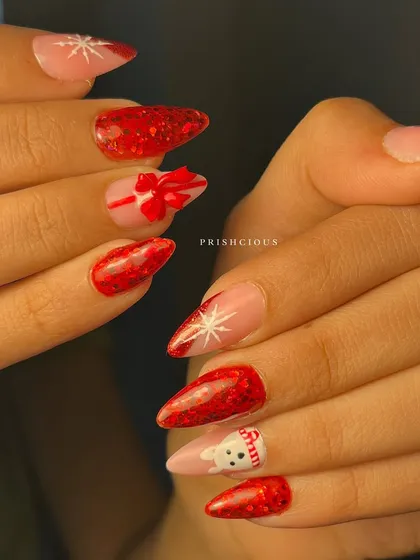 A closer view of the adorable details in this Christmas nail set. You can see the texture on the glitter nails and the tiny features on the hand-painted snowman.