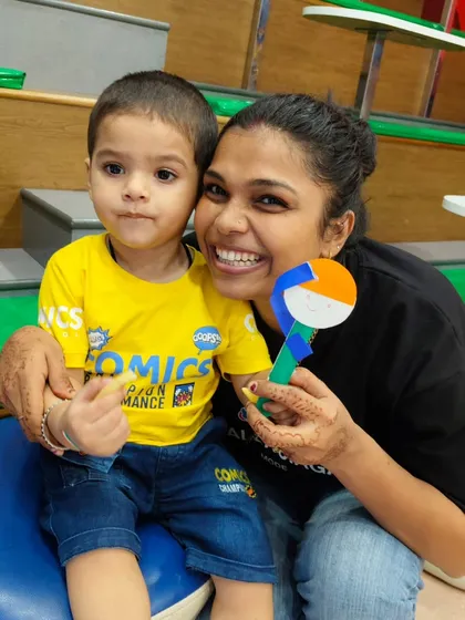 A mother and her son show off their handmade tri-color craft, a fun and educational activity from our Independence Day event.