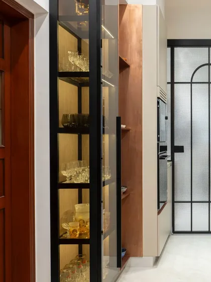 The internal lighting in this glass-fronted crockery unit turns a simple storage cabinet into an elegant display. It highlights the glassware beautifully, adding a touch of glamour and warmth to the kitchen.