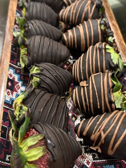 My chocolate-coated strawberries are a seasonal favorite. Each one is hand-dipped and decorated, making them a beautiful and delicious treat.
