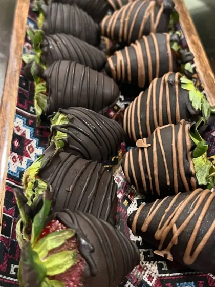A tray of my beautiful chocolate-covered strawberries, drizzled with even more chocolate. They are perfect for parties or as a special treat for yourself.