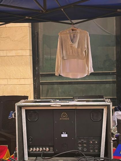 The reality of a location shoot. This image shows some of the equipment and a piece from the wardrobe hanging in the background, ready for the next shot.