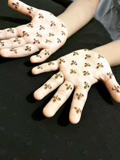 A very minimalist design for a child, with tiny scattered motifs on the palms.