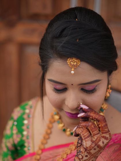 A delicate close-up of Madhushree's engagement makeup, highlighting the intricate details of her nose ring and eye makeup.