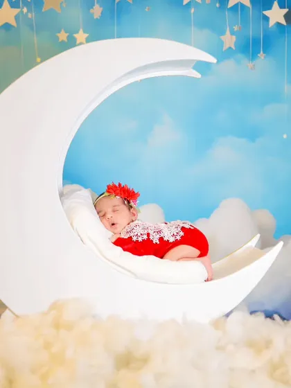 Another variation of our moon prop theme, this time with a newborn girl in a lovely red lace outfit.