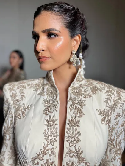 A close-up of the finished makeup look for a model at the Manish Malhotra Bridal Couture show, highlighting the glowing skin and defined features.