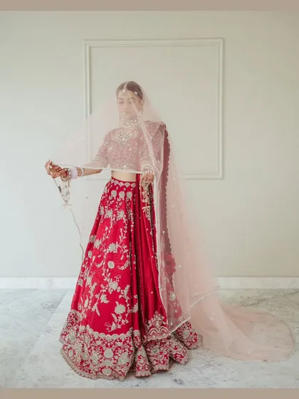 An ethereal portrait of the bride under her veil. The soft, sheer fabric creates a dreamy and romantic mood, adding a layer of mystery and elegance.