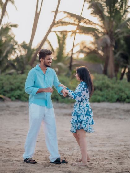 A playful dance on the sand as the sun sets. This shot captures the fun and carefree spirit of the couple's relationship during their romantic beach pre-wedding session.