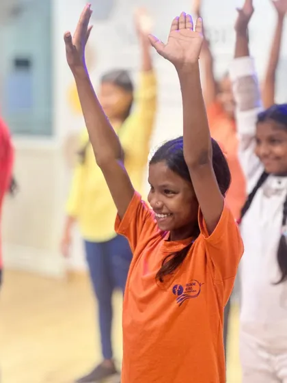 A young girl from the Dream Girl Foundation NGO smiling and dancing during our 7th-anniversary celebration at the studio.