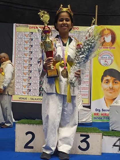A champion's pose. This student's victory is a proud moment for all of us at Team ASHA.