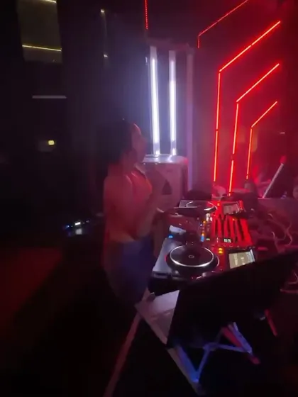 The red neon lights set the mood for an intense party. Here I am, surrounded by the club's atmosphere, getting ready to drop the next banger.