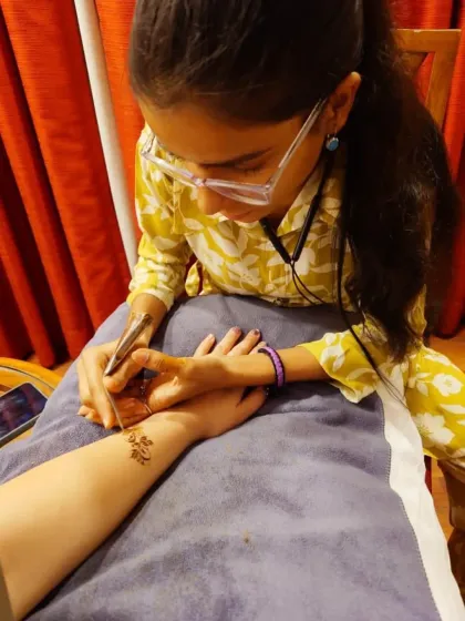A candid shot of me applying a tiny baby elephant to my client's wrist. It's these small, custom details that make a design special.