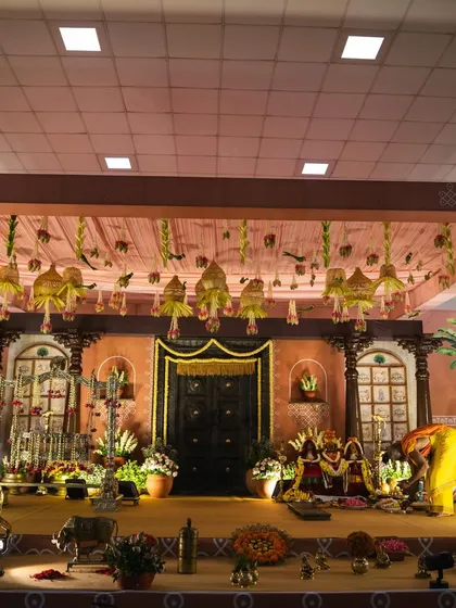 We designed this elaborate stage for little Mitharv's naming ceremony, creating a "South Indian village" theme. The decor featured a traditional door, terracotta tones, and vintage elements to bring the nostalgic concept to life.