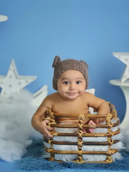Another variation of the 6-month milestone shoot. This little bear is sitting in a rustic basket against a dreamy blue sky backdrop.