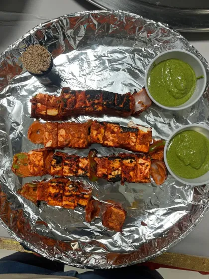 A close up of my Paneer Tikka, marinated and grilled perfectly, served with fresh mint chutney. It's a popular starter for all types of events, from corporate parties to weddings.