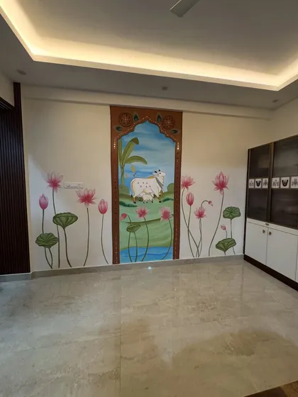 This wider shot shows how the Pichwai mural integrates with the room's furniture and lighting, becoming the undeniable heart of the home.