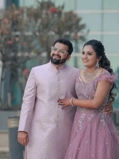 A happy, candid portrait of the couple in their pastel engagement outfits. Their smiles show their genuine excitement and love.