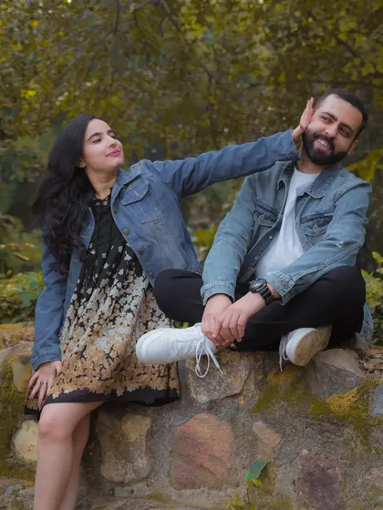 A simple, candid moment during a pre-wedding shoot in a park. Her playful gesture and his happy smile show the easy, comfortable love they share.