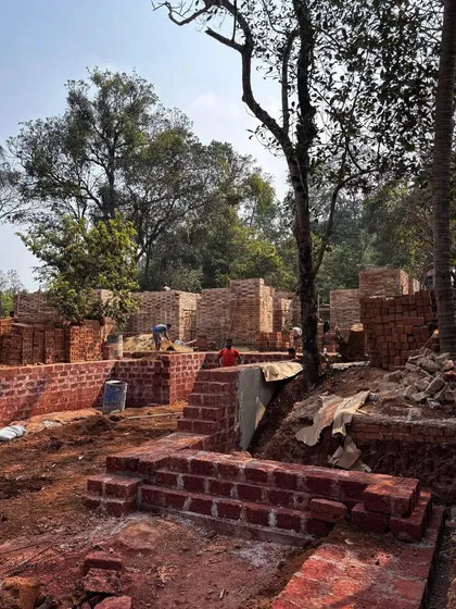An overview of the Aadi Villa site, showing the load-bearing earth block walls taking shape. The design is a maze-like collection of spaces that will be integrated with the surrounding Goan landscape.