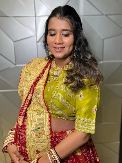 A traditional look for a Godh Bharai ceremony. The client is wearing a beautiful red and green outfit, and I created a classic makeup look to match.