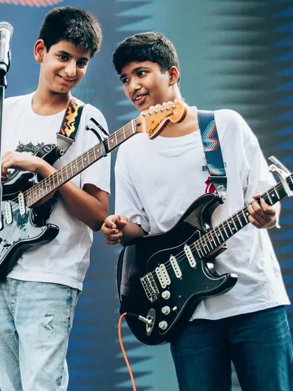 Two of our guitar students sharing a moment on stage at Art Mumbai. Learning with friends is a big part of the fun, and we often see our students form their own bands.