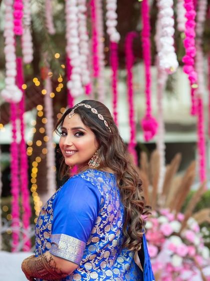 A playful glance over the shoulder. This hairstyle is perfect for a fun, festive event like a Mehendi or Sangeet.