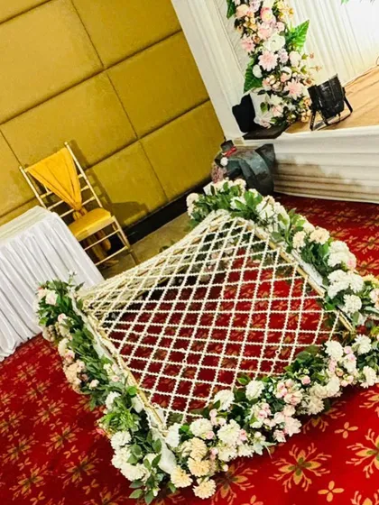 A beautifully decorated floral 'jaal' for a pre-wedding ritual, showing attention to traditional details.