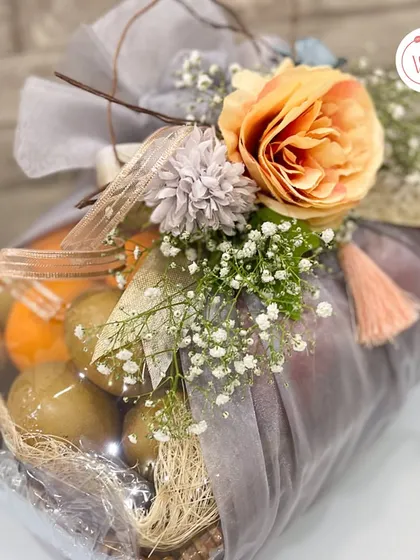 Another view of the fruit basket, showing the variety of fresh fruits like kiwis and oranges included.