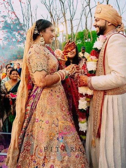The Varmala moment, where two souls become one under a shower of petals. The decor is the backdrop, but their love story is the main event.