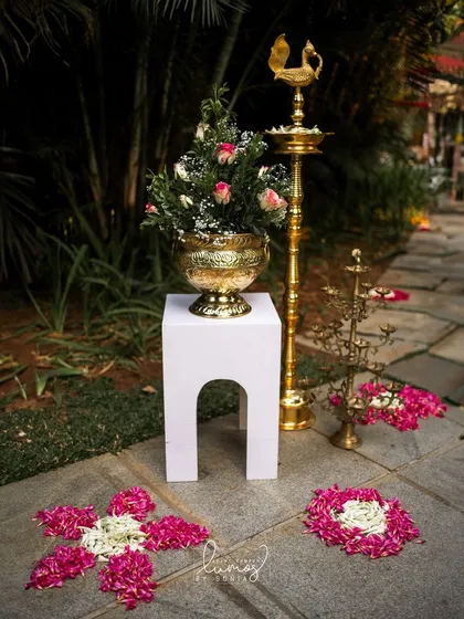 A beautiful floral arrangement with a traditional brass lamp, creating a serene and welcoming atmosphere.