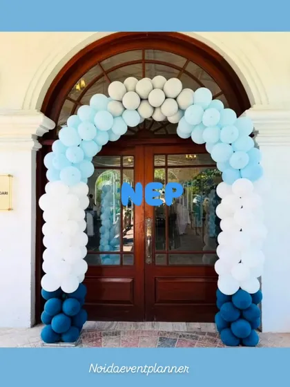 A classic balloon arch in shades of blue and white makes for a simple yet elegant entrance for a royal prince themed birthday party.