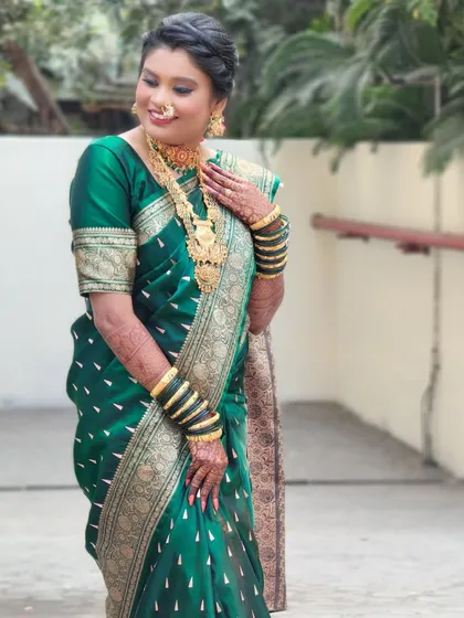 Another pose of the lovely bride Sandhya, her smile radiating happiness. The makeup enhances her features without overpowering the traditional attire.