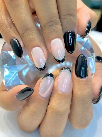 A hint of glitter can never go wrong. This manicure puts a twist on the French look, with a sheer pink base and a black tip outlined with a fine silver glitter line.
