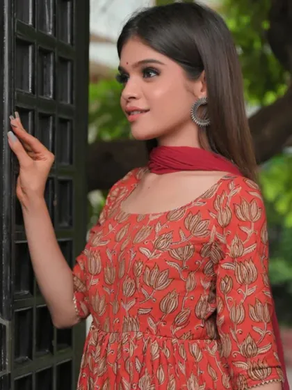 A simple red floral print kurta with a matching dupatta. This is a classic, comfortable outfit that is perfect for casual outings or daily wear.