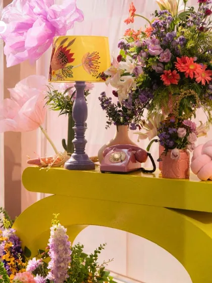 Color, texture, and playful design come together in this detail shot from a Moroccan-inspired party. The sculptural yellow console, vintage phone, and vibrant floral arrangement highlight my ability to style bold and unforgettable events.