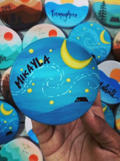 "Mikayla" is written on this magnet depicting a magical, starry night sky with a crescent moon. Each magnet is personalized with a name.