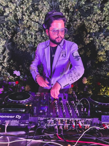 Grooving and moving. A shot of me mixing at an outdoor event, surrounded by beautiful floral decor.
