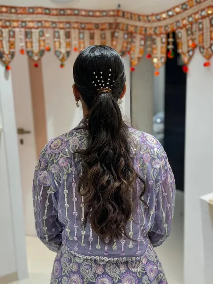 A sleek and modern ponytail with a touch of sparkle, perfect for a sangeet or cocktail party.