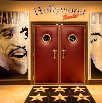 Make a grand entrance to your personal cinema. We create fully themed experiences, including custom doorways like this "Hollywood Theater" entrance, complete with classic marquee signage, Oscar-style handles, and a walk-of-fame floor design.